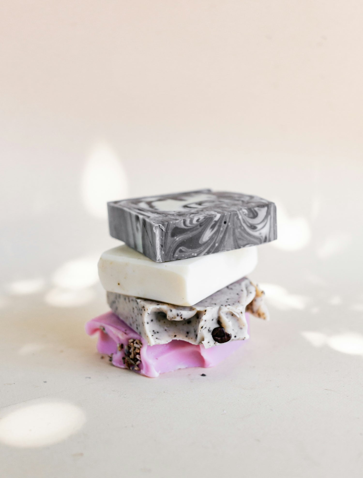 Stack of marbled soap bars on a light background